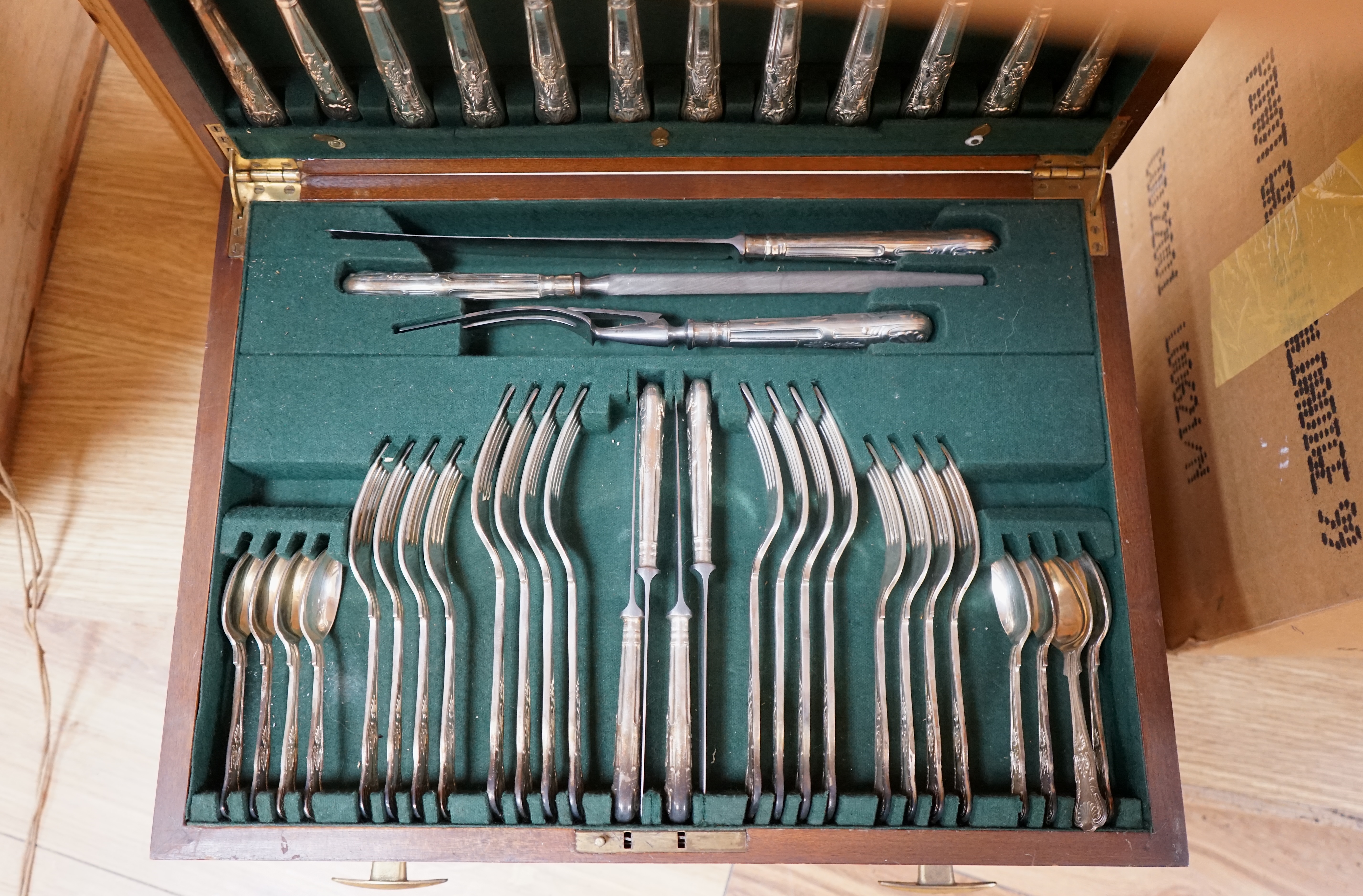 A walnut cased canteen of cutlery with drawer, retailed by Harrods. Condition - one dessert spoon missing